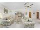 Living room showcasing two floral print sofas, a glass coffee table, and built-in shelving at 615 Apple Ln, Englewood, FL 34223