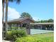 Community shuffleboard courts with covered seating areas at 615 Apple Ln, Englewood, FL 34223