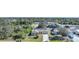 An aerial shot showing a single-Gathering house with a driveway and yard in a residential area at 6176 Catalan St, Englewood, FL 34224