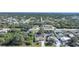 Aerial view of a house in a residential neighborhood with tree-lined streets and other homes at 6176 Catalan St, Englewood, FL 34224