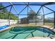 Screened-in pool with a wooden shed in the background at 6176 Catalan St, Englewood, FL 34224