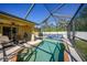 Inviting screened-in pool with lounge chairs and a shed at 6176 Catalan St, Englewood, FL 34224