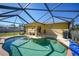 Inviting screened pool area with lounge chairs and outdoor kitchen at 6176 Catalan St, Englewood, FL 34224