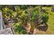 Lush tropical landscaping lines a walkway in the backyard at 62 Marker Rd, Rotonda West, FL 33947