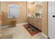 Bathroom with double vanity, beige tile flooring, and a window at 62 Marker Rd, Rotonda West, FL 33947