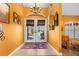 Bright entryway with double doors, terracotta tile floor, and southwestern accents at 62 Marker Rd, Rotonda West, FL 33947