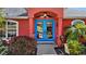 Close-up of blue double front doors with glass panels and arched entryway at 62 Marker Rd, Rotonda West, FL 33947