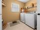 Laundry room with washer, dryer, and storage shelves at 62 Marker Rd, Rotonda West, FL 33947