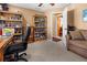 Home office with built-in bookshelves, a desk, and a comfortable couch at 62 Marker Rd, Rotonda West, FL 33947