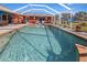 Relaxing pool area with screened enclosure at 62 Marker Rd, Rotonda West, FL 33947