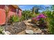 Landscaped side yard with stone path and tropical plants at 62 Marker Rd, Rotonda West, FL 33947