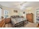 Spacious bedroom with king-size bed, wood furniture, and ceiling fan at 6699 San Casa Dr # T1, Englewood, FL 34224