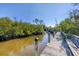 Wooden dock with seating area providing access to the waterway at 6699 San Casa Dr # T1, Englewood, FL 34224