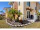 Landscaped yard with palm trees and a stone border at 6699 San Casa Dr # T1, Englewood, FL 34224