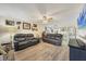 Comfortable living room featuring two leather sofas and a view of the dining area at 6699 San Casa Dr # T1, Englewood, FL 34224