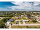 Aerial view of a residential neighborhood showcasing single-Gathering homes and lush landscaping at 7035 Sunnybrook Blvd, Englewood, FL 34224