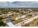 Aerial view of a single Gathering home with a large yard in a residential neighborhood at 7035 Sunnybrook Blvd, Englewood, FL 34224