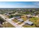 Aerial view of a single Gathering home with a large yard in a residential neighborhood at 7035 Sunnybrook Blvd, Englewood, FL 34224