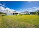 Large grassy backyard of the home at 7035 Sunnybrook Blvd, Englewood, FL 34224