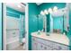 Clean bathroom with a teal vanity and shower/tub combo at 7035 Sunnybrook Blvd, Englewood, FL 34224