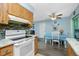 Kitchen with white appliances and wood cabinets at 7035 Sunnybrook Blvd, Englewood, FL 34224