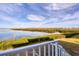 Scenic waterfront view from deck, lush landscaping, and calm water at 7180 Brittany Cir, Englewood, FL 34224