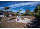 Landscaped backyard with fire pit and seating at 7336 Brookhaven Ter, Englewood, FL 34224