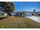 House exterior showcasing a white single-story home with a garage and a well-maintained lawn at 7336 Brookhaven Ter, Englewood, FL 34224