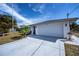 White single-story house with a white garage door and a spacious driveway at 7336 Brookhaven Ter, Englewood, FL 34224