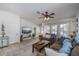 Living Room with brown couches, blue throw pillows, and a large TV at 7336 Brookhaven Ter, Englewood, FL 34224