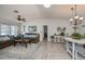 Open concept living room and dining area with brown sectional sofa and a white dining set at 7336 Brookhaven Ter, Englewood, FL 34224