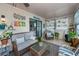 Relaxing sunroom with wicker furniture and potted plants at 7336 Brookhaven Ter, Englewood, FL 34224