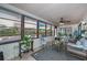 Bright sunroom with wicker furniture and tiled floor at 7336 Brookhaven Ter, Englewood, FL 34224