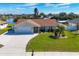 Single-Gathering home with two-car garage and lush lawn at 7398 Spinnaker Blvd, Englewood, FL 34224