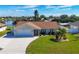 Single-Gathering home with a two-car garage and manicured lawn at 7398 Spinnaker Blvd, Englewood, FL 34224