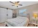 Bedroom with queen bed, barn doors, and ceiling fan at 7398 Spinnaker Blvd, Englewood, FL 34224