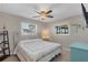 Bright bedroom with a queen-size bed and built-in shelving at 7398 Spinnaker Blvd, Englewood, FL 34224