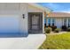 Front entry with screen door and landscaping at 7398 Spinnaker Blvd, Englewood, FL 34224