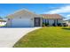 Single-story home with attached garage and landscaped yard at 7398 Spinnaker Blvd, Englewood, FL 34224