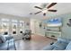 Living room with tile floors, comfy seating, and a large-screen TV at 7398 Spinnaker Blvd, Englewood, FL 34224