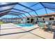 Enclosed pool and patio area with seating at 7398 Spinnaker Blvd, Englewood, FL 34224