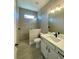 Clean bathroom with a walk-in shower, white vanity, and tile flooring at 7410 Grand Concourse St, Englewood, FL 34224