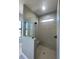 Bathroom with a large walk-in shower and neutral tile at 7410 Grand Concourse St, Englewood, FL 34224