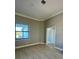 Spacious bedroom with large window and neutral color scheme at 7410 Grand Concourse St, Englewood, FL 34224