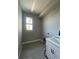 Laundry room with white cabinetry and vinyl flooring at 7410 Grand Concourse St, Englewood, FL 34224