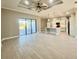 Open living room and kitchen area with high ceilings and tile flooring at 7410 Grand Concourse St, Englewood, FL 34224