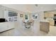 Bright dining area with a round table and four chairs, adjacent to the kitchen at 7438 Banbury Ter, Port Charlotte, FL 33981