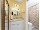 Bright bathroom featuring a classic white vanity, a well-lit mirror, and a shower with a decorative curtain at 7522 Sea Mist Dr, Port Charlotte, FL 33981