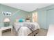 Bright bedroom features light green walls and connects to a bathroom for convenience and privacy at 7522 Sea Mist Dr, Port Charlotte, FL 33981