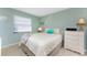 Cozy bedroom with light green walls, a large window, and comfortable-looking bed at 7522 Sea Mist Dr, Port Charlotte, FL 33981